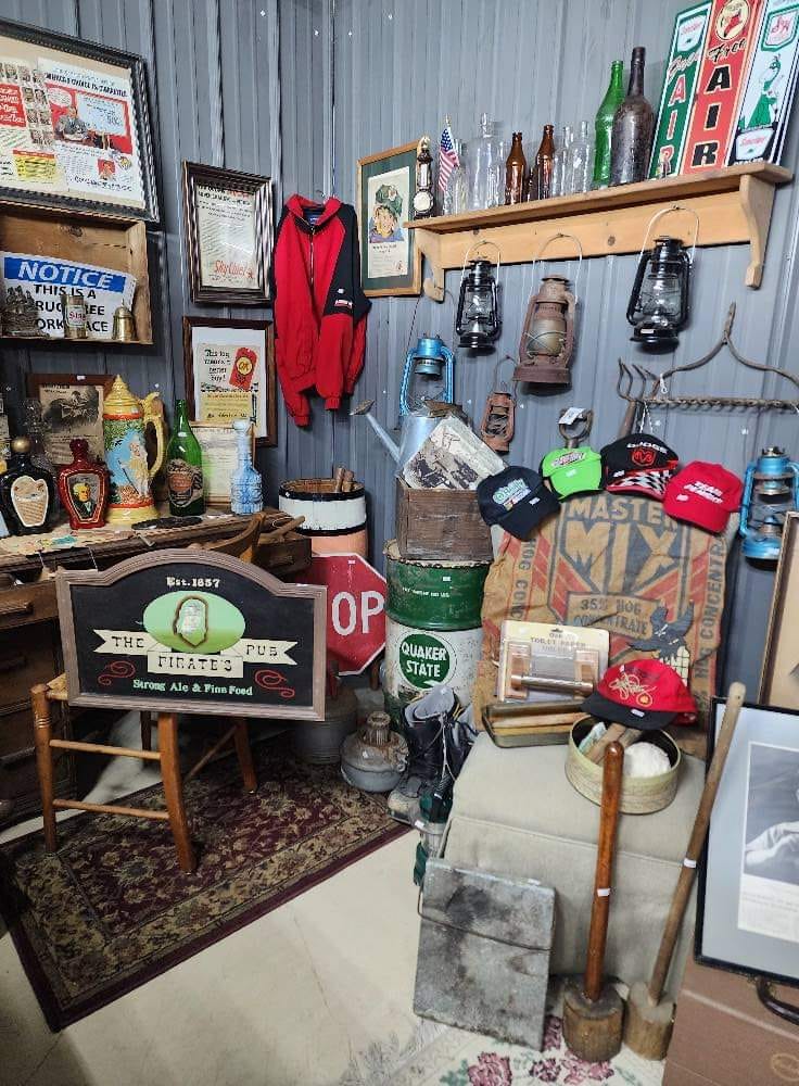 display of various antiques such as lanterns, signs, and bottles of various shapes