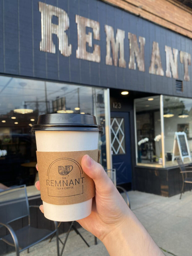 Holding a coffee cup outside Remnant Coffee