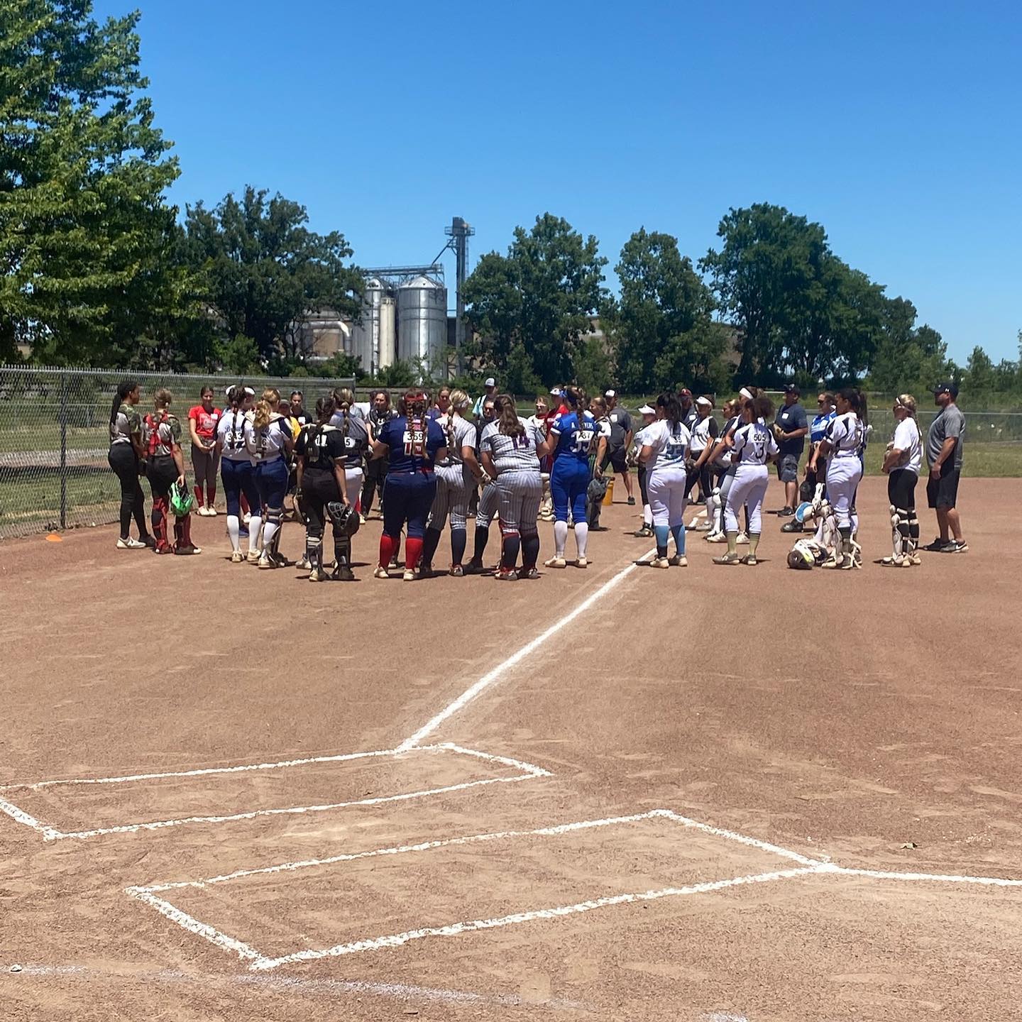 Women softball teams gathered on the field.