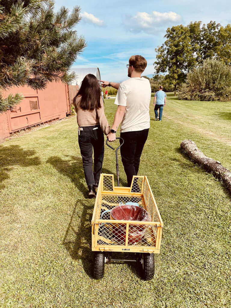 Couple pulling a wagon for apple picking at Lawrence Orchard.