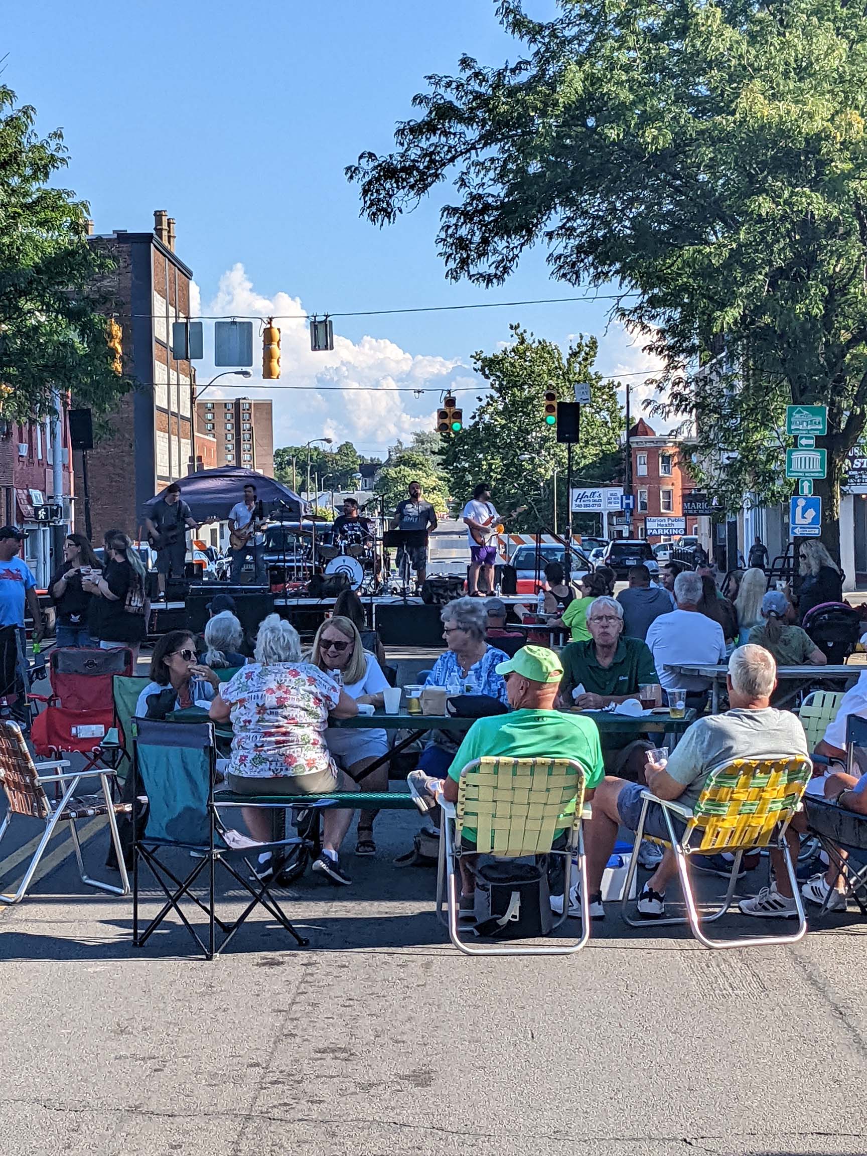A crowd in the street of downtown Marion, Ohio enjoying live music during a Third Thursday event.
