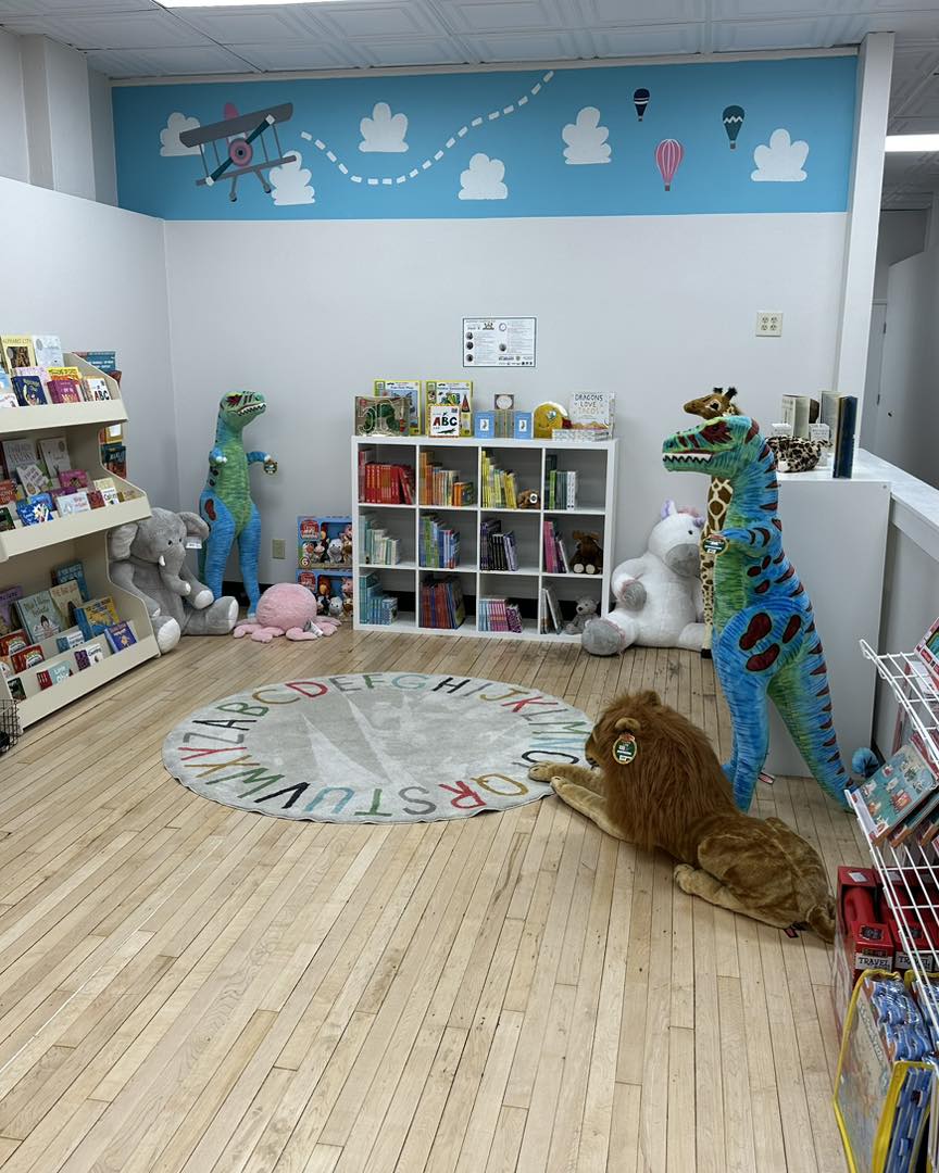room with children's toys, stuffed animals, and open space for storytime