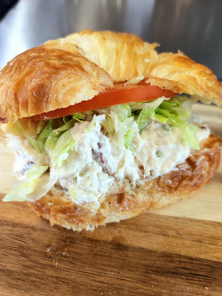 croissant stuffed with chicken salad, lettuce, and tomato