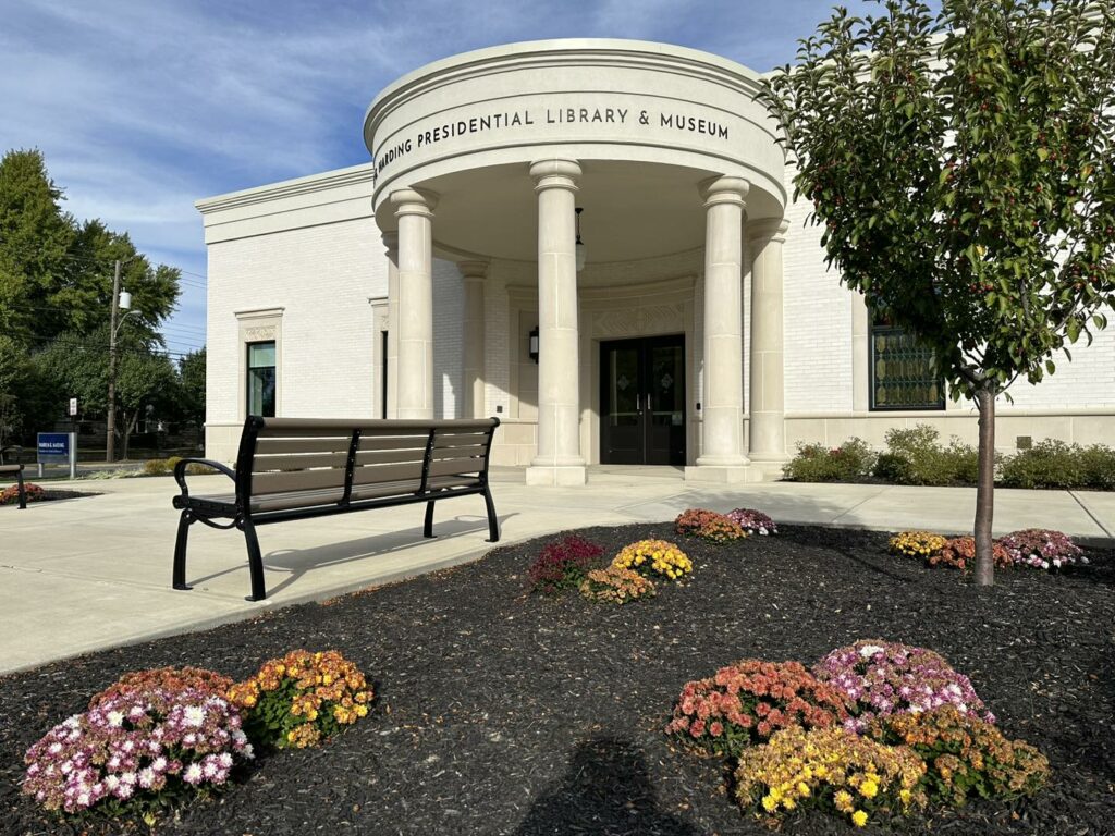 circular entrance with pillars and fall flowers