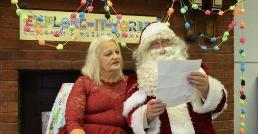 Santa and Mrs. Clause reading a list