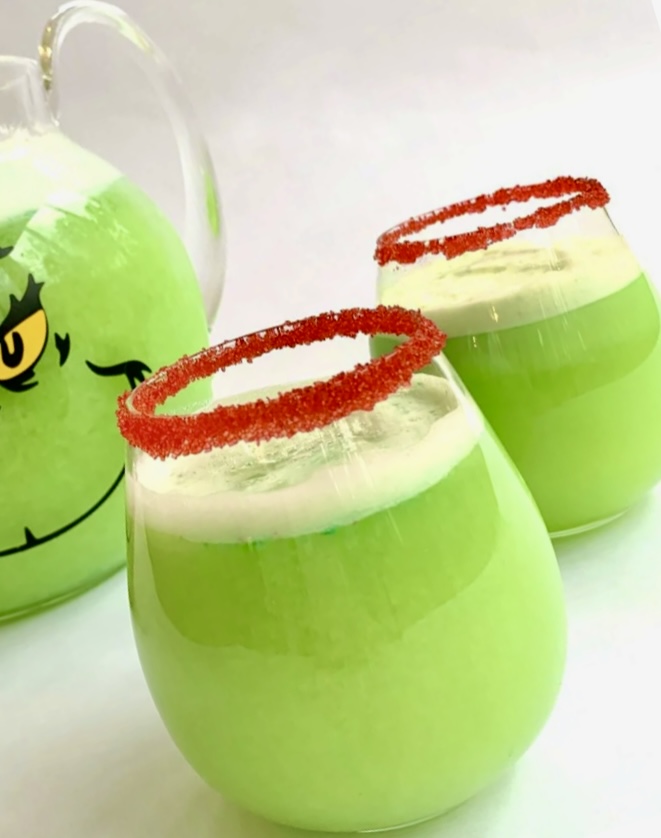 Grinch pitcher with glasses filled with green punch