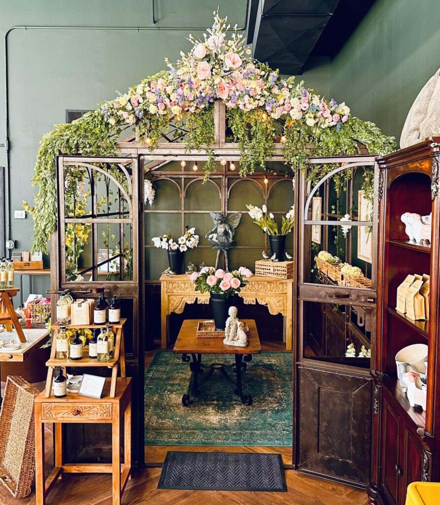 Gazebo draped with florals and home decor items displayed