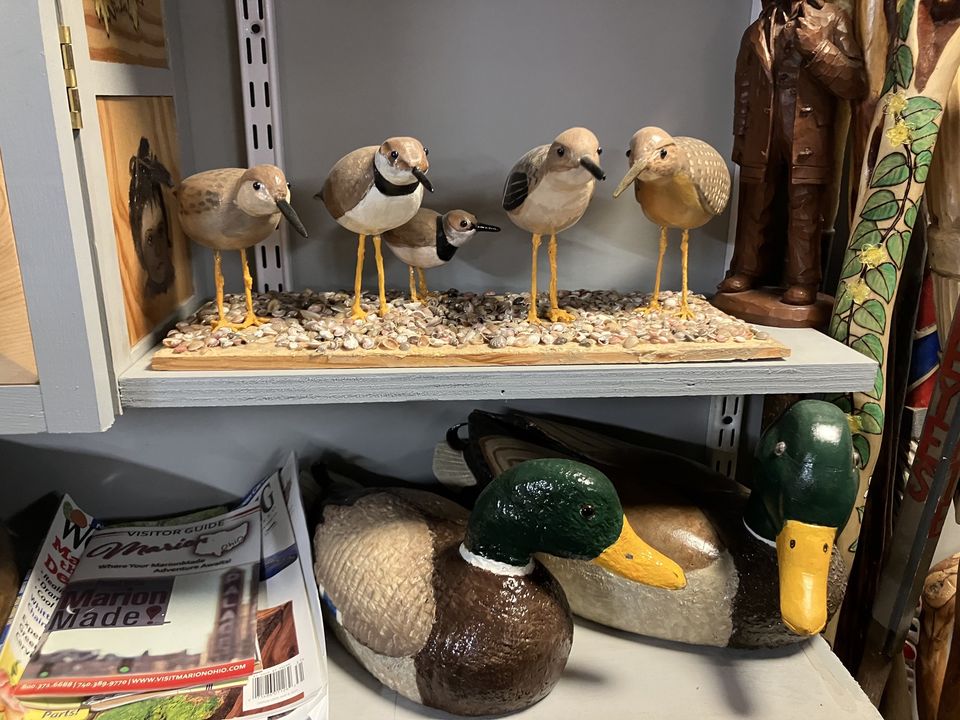 wooden sculptures of ducks and birds