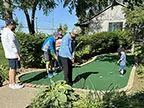 Family playing putt-putt at Paradise Park in Marion.